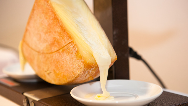 raclette cheese melting onto plate