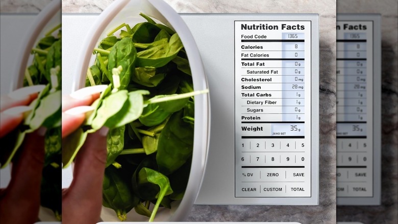 Weighing spinach on a Greater Goods nutritio scale