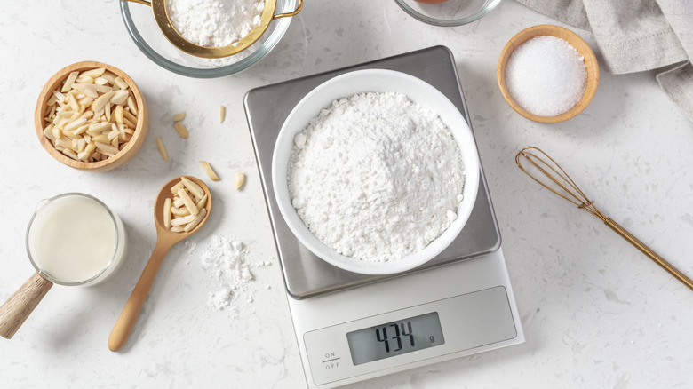 Weighing flour on a kitchen scale