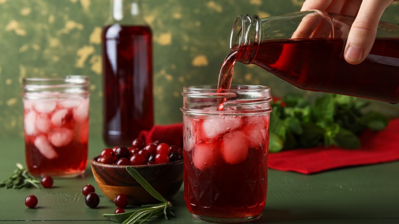 pouring cranberry juice over ice