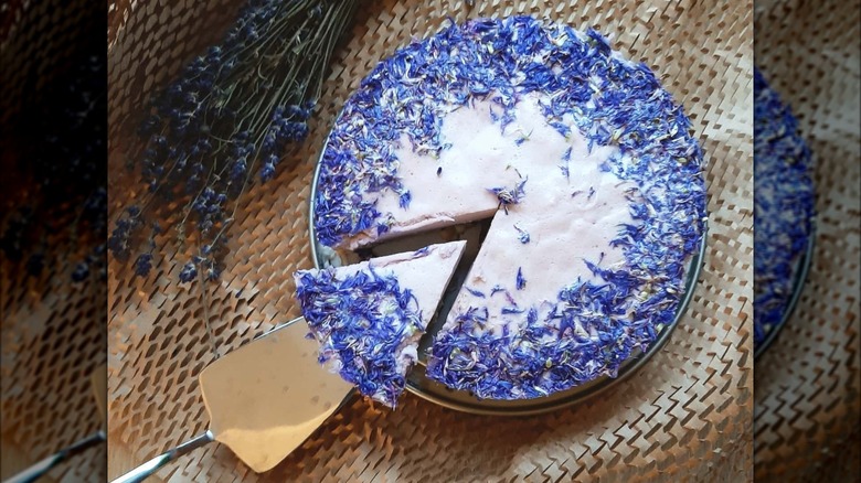 white cream cake with cornflower petal decoration