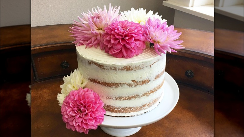 white layered cake with dahlia flower topping