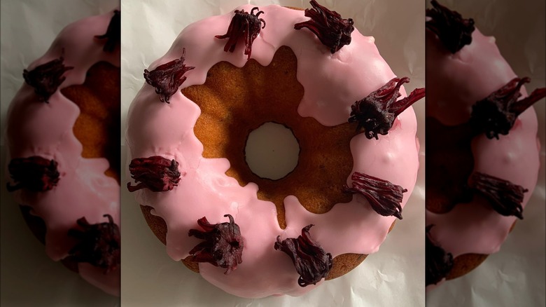 pink glazed bundt cake with hibiscus flowers