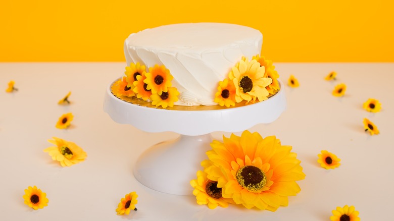 white cake with sunflower garnishes