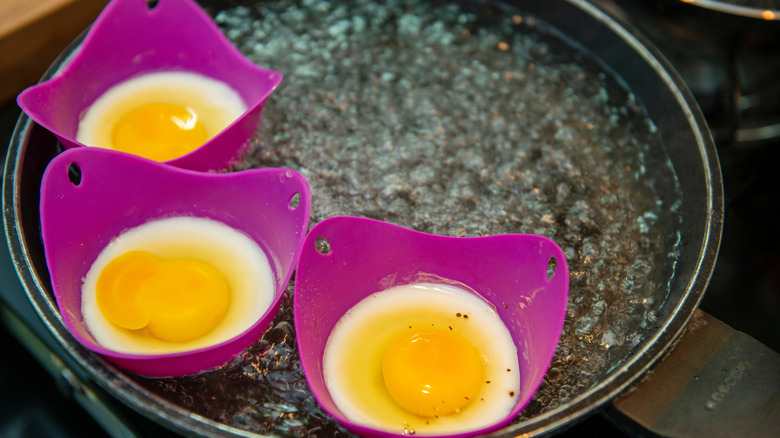 purple silicone egg poachers in boiling water