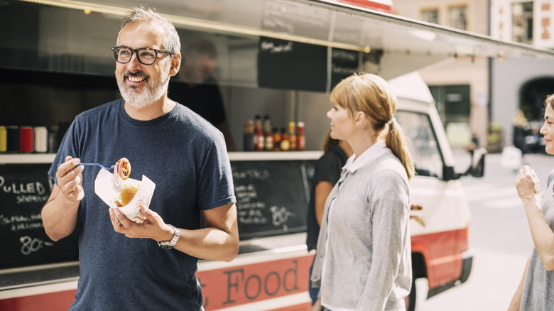 People eating at food truck