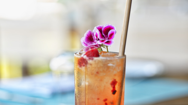 whiskey cocktail with edible flower