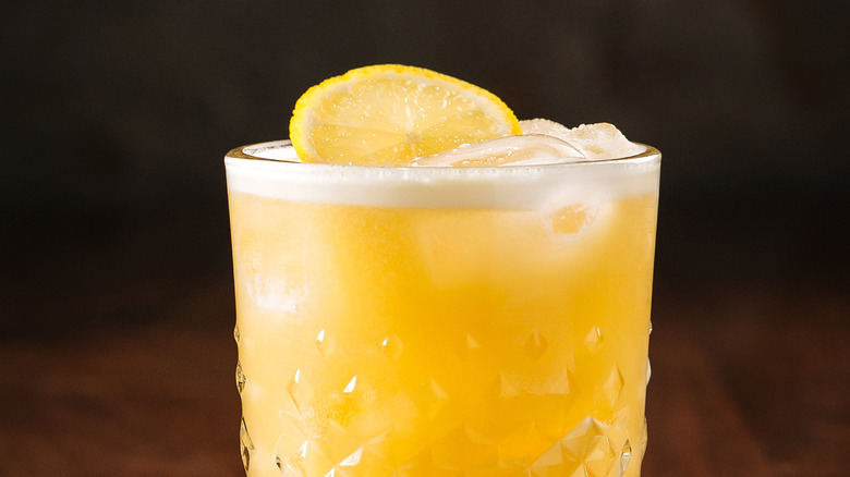 whiskey sour with lemon wedge