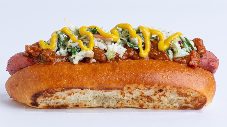 hot dog with collard green coleslaw