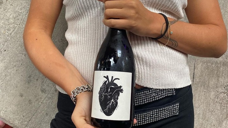 person holding wine bottle