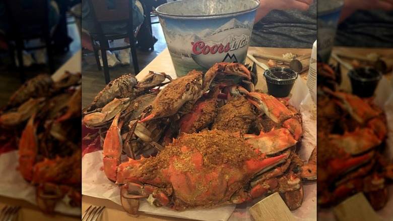 Jumbo crab and Coors bucket on table