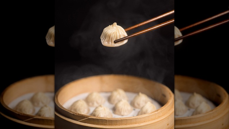 chopsticks grabbing soup dumpling