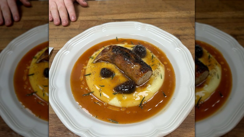 plated chicken neck sausage over potatoes