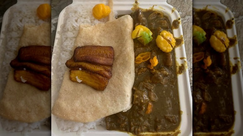 Curry goat with roti and rice