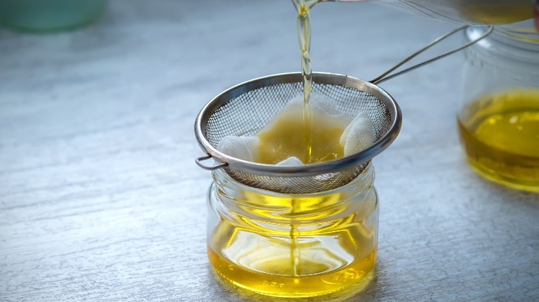 pouring clarified butter through sieve