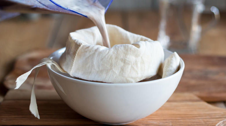 straining milk through nut bag