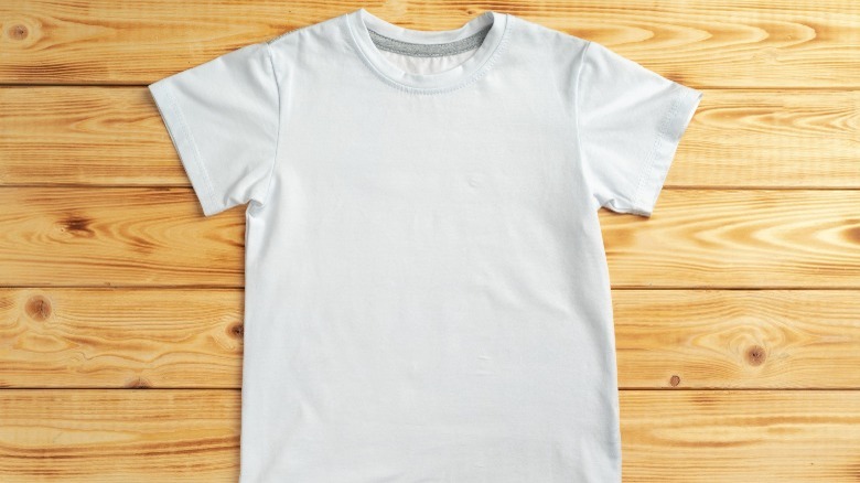 white t-shirt on wooden surface