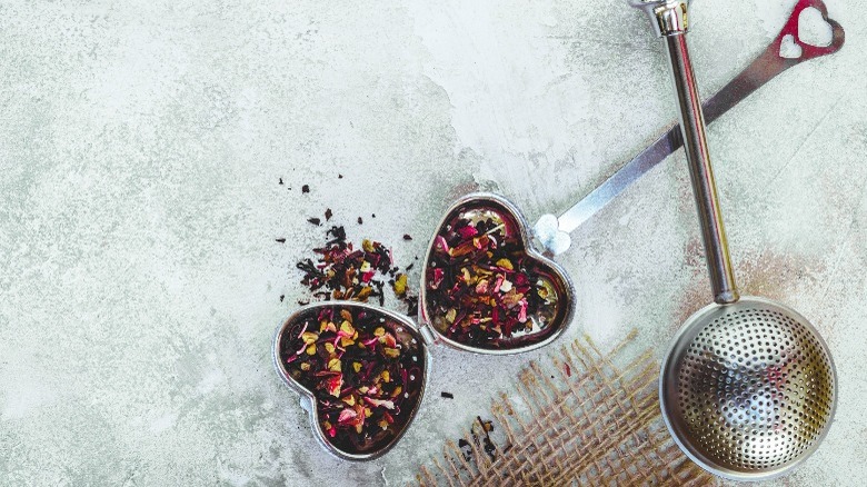 two tea infusers with tea