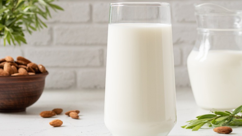 Almond milk on white background