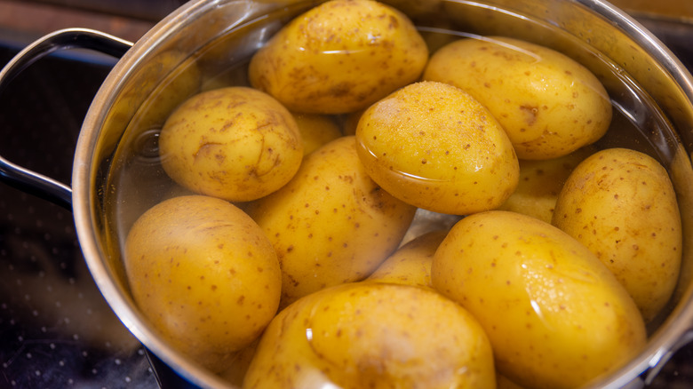 Potatoes soaking in a saucepan