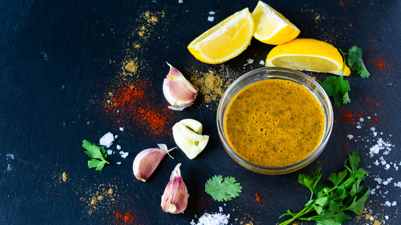 Closeup of a marinade with lemon, galric, and parsley