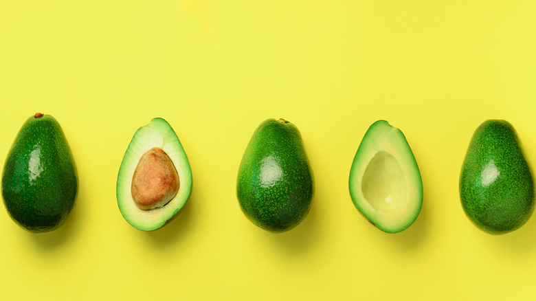 Avocados against yellow backdrop