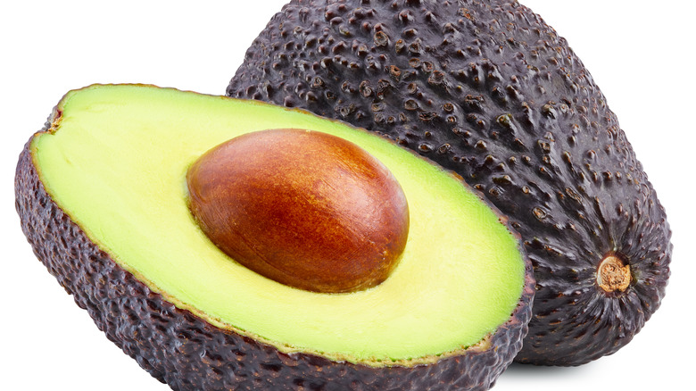 Sliced avocado against white backdrop