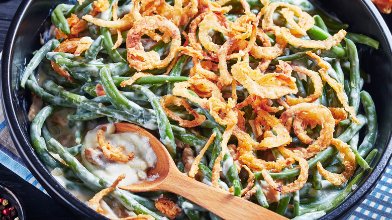 Green bean casserole with wooden spoon