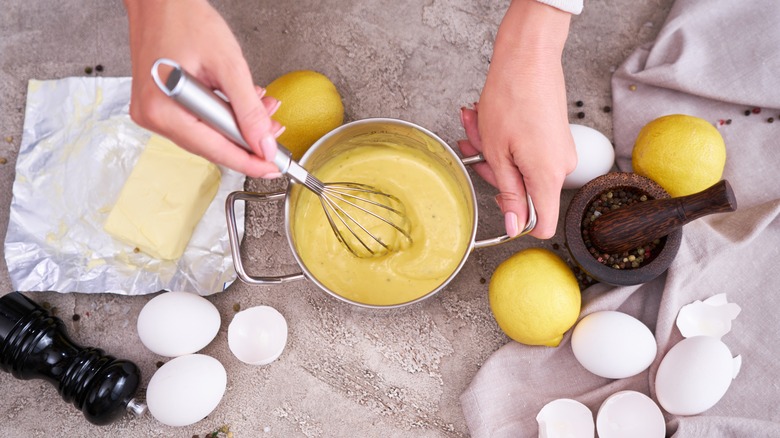 Whisking hollandaise with ingredients