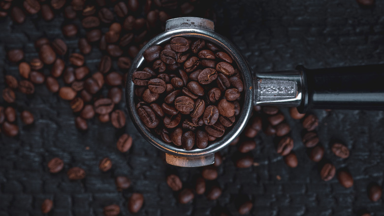 Spilt coffee beans with portafilter