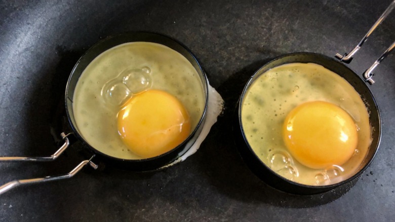 Eggs cooking in egg rings