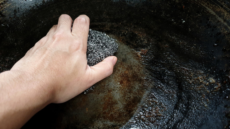 Hand scrubbing cooktop with steel wool 