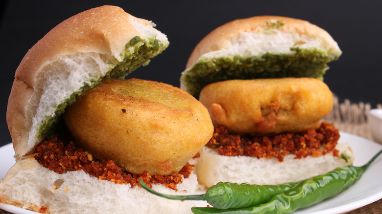 two vada pavs on plate