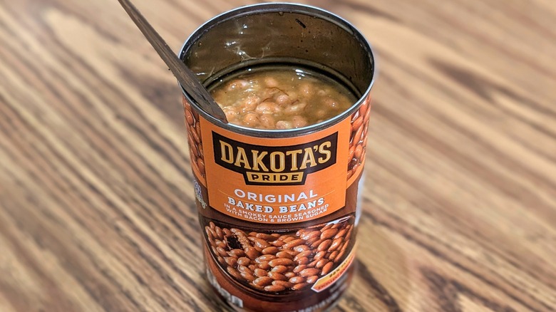 Open can of Dakota's Pride baked beans on wood table