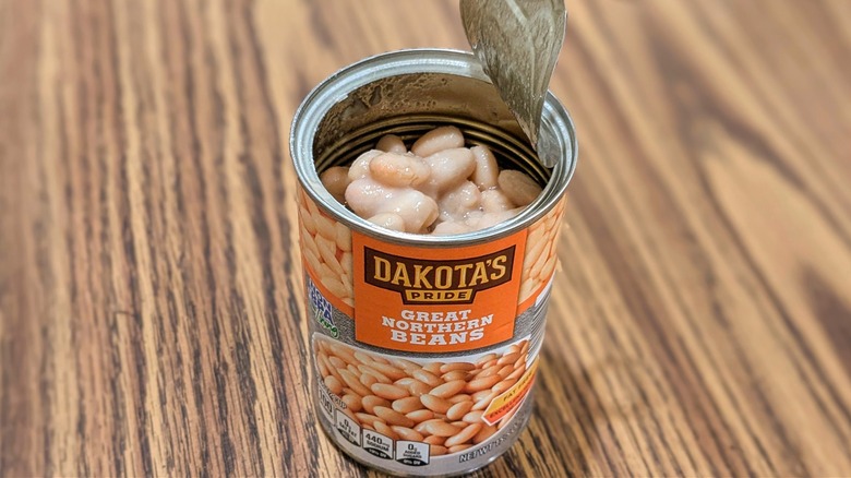 Open can of Dakota's Pride Great Northern Beans on wood table