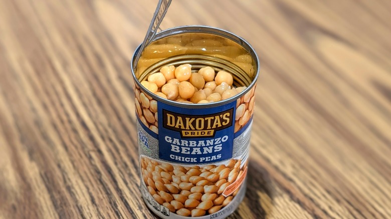 Open can of Dakota's Pride garbanzo beans on wood table
