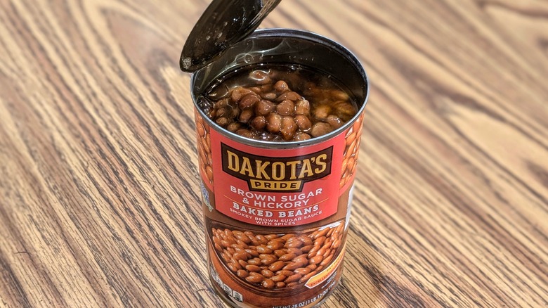 Open can of Dakota's Pride brown sugar and hickory baked beans on wood table
