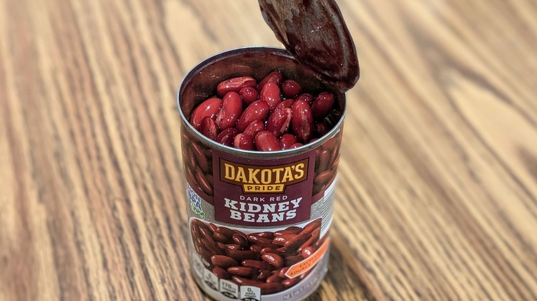 Open can of Dakota's Pride red kidney beans on wood table