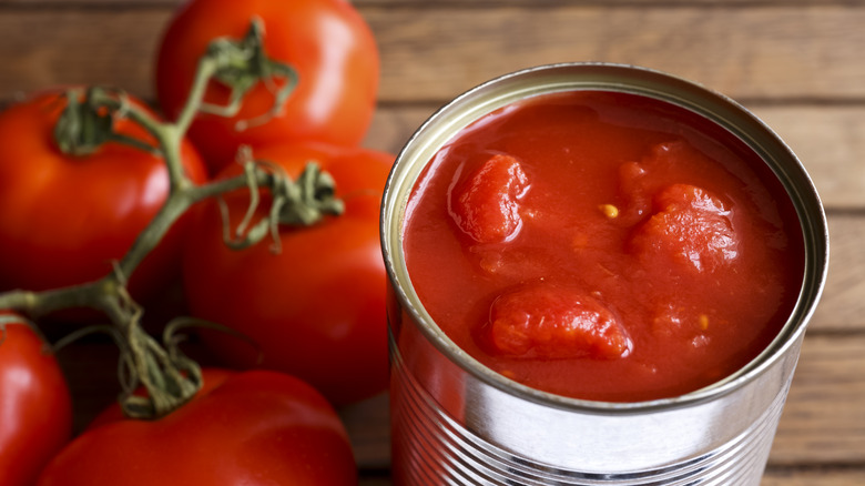 Canned tomatoes open on counter