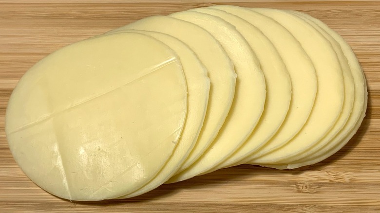 sliced provolone on cutting board