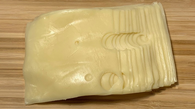 Swiss cheese slices on board