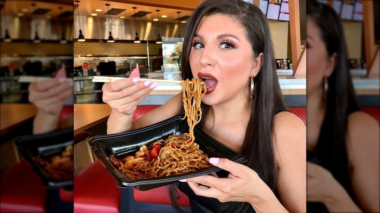 woman eating chinese from pick up stix