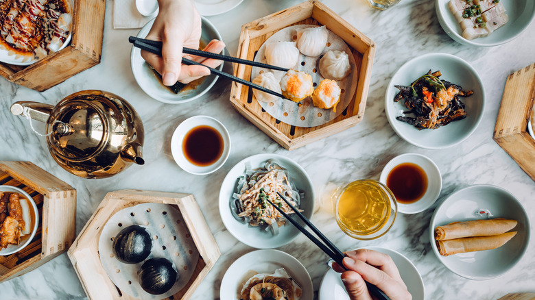 variety of chinese dishes arranged on table