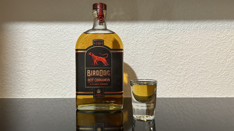 A bottle and shot of Hot Cinnamon Bird Dog Whiskey