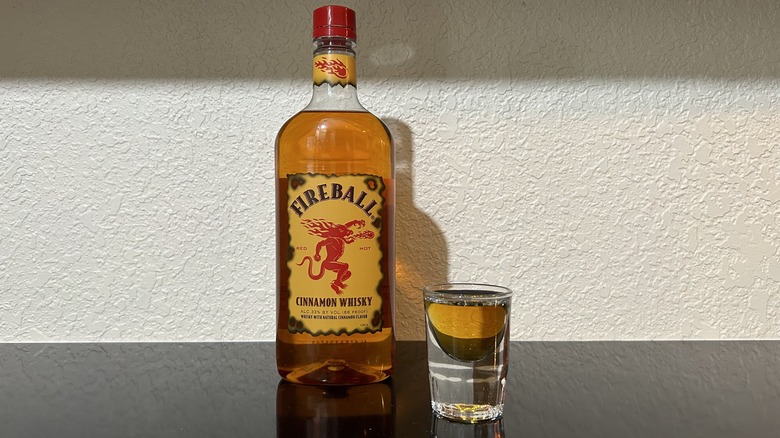 A bottle and shot of Fireball Cinnamon Whiskey