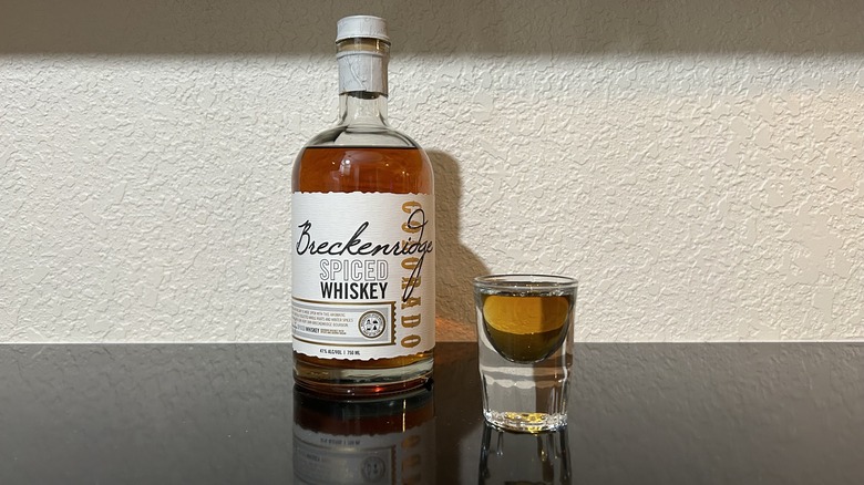 A bottle and shot of Breckenridge Spiced Whiskey