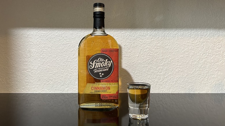 A bottle and shot of Ole Smoky Cinnamon Whiskey