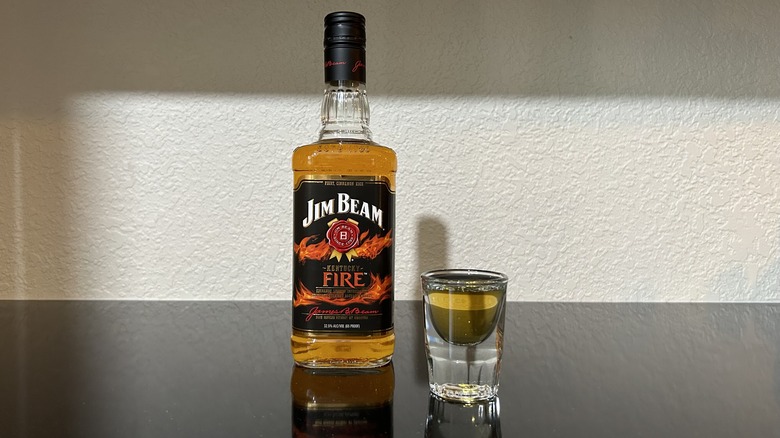 A bottle and shot of Jim Beam Kentucky Fire whiskey