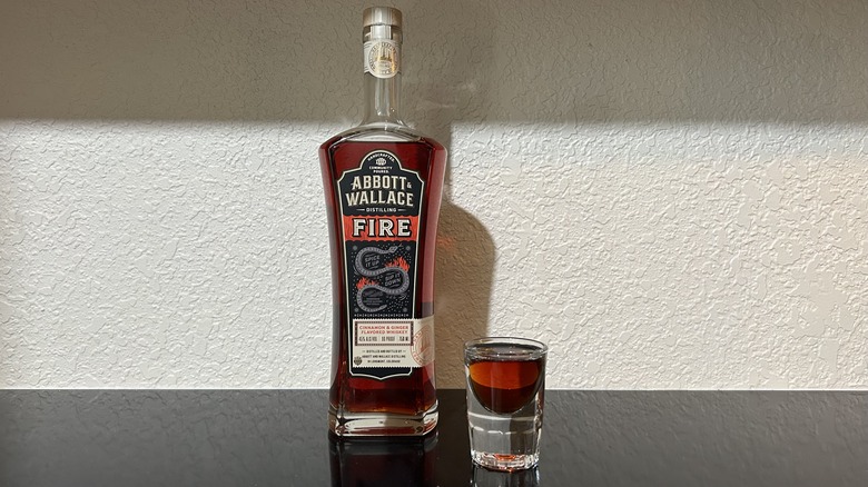 A bottle and shot of Abbott & Wallace cinnamon whiskey