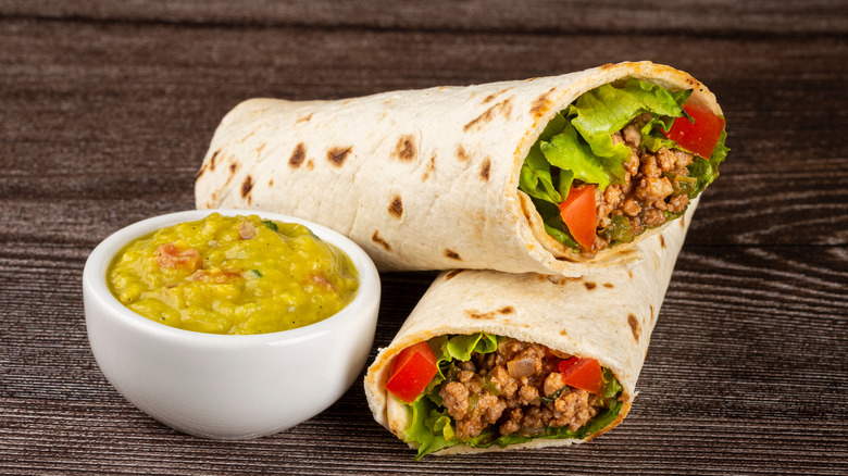 beef burritos on wooden surface